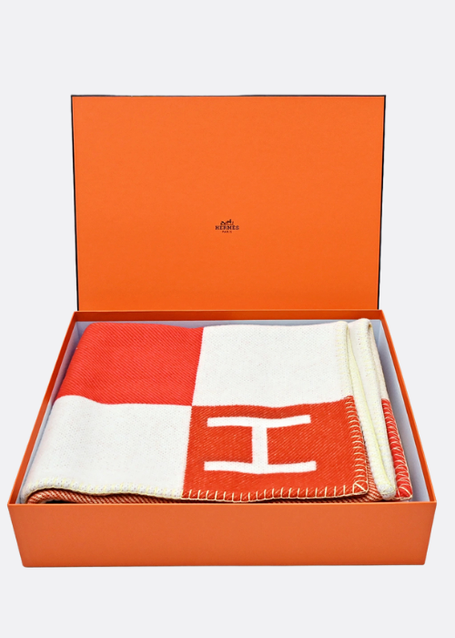 avalon vibration throw blanket in orangw & White